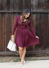 Chaussures blanches et un sac à la robe de couleur vin