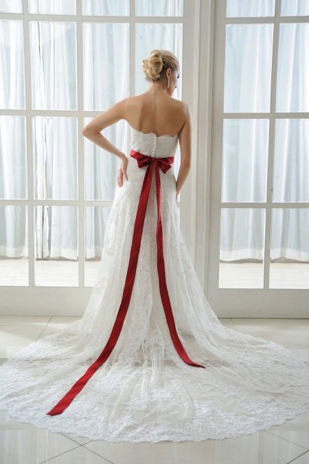 Robe de mariée avec un noeud rouge à l'arrière